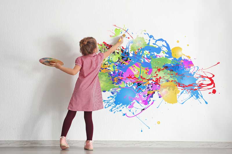 girl painting on the wall