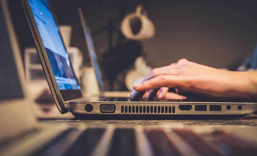 hands typing on a laptop computer