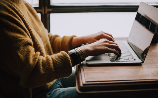 person sitting at laptop