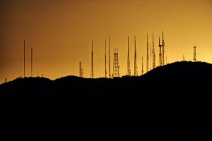 A silhouette image of telecommunications towers