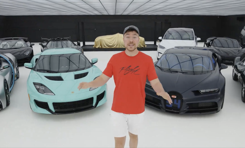A screenshot of the video that earned MrBeast over $250k on X. The youtuber MrBeast stands in from of a showroom of supercars.