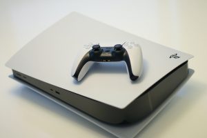 A photo of a Sony Playstation 5 console and controller