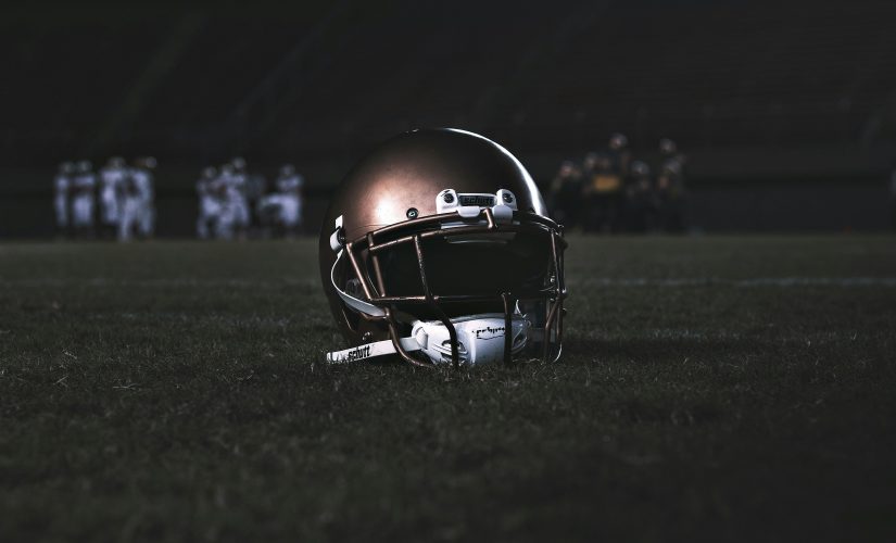 A photo of an American Football helmet on the pitch.