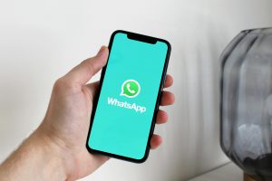 Whatsapp logo on a smartphone / WhatsApp working on a file sharing feature similar to AirDrop