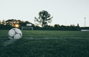 Soccer ball on grass in dusk