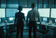 A generated image of male and female agents team standing in front of computer screens in a control centre.