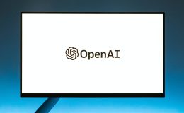 An image of a laptop screen with OpenAI logo on it.