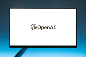 An image of a laptop screen with OpenAI logo on it.