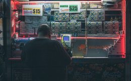 A man buys a lottery ticket at a kiosk / Dutch politician poses complete ban on gambling advertising