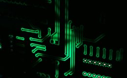 A green circuit board on a black background