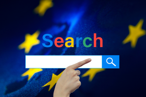 Google introduces new search update to comply with EU tech rules. A hand pointing to a stylized search bar with the word 