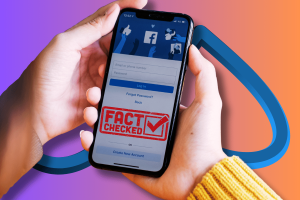 Meta issues final date to end CrowdTangle. A person's hand holding a smartphone with the Facebook login screen displayed, overlayed with a large "FACT CHECKED" stamp.