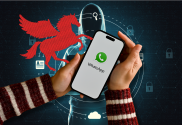 Pegasus spyware US court orders maker to hand over code to WhatsApp. An illustration of a hand holding a smartphone with the WhatsApp logo displayed on the screen. The background features a stylized red Pegasus figure emerging from digital graphics that suggest cybersecurity, with icons representing user identity and lock symbols in a network-like pattern. The Pegasus and phone are overlaid on a dark backdrop with digital connections and cybersecurity elements.