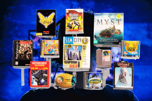 World Video Game Hall of Fame 2024 finalists include nostalgic gems. A collection of classic video game boxes and cartridges, displayed against a dynamic blue background, representing the 2024 finalists for the World Video Game Hall of Fame.