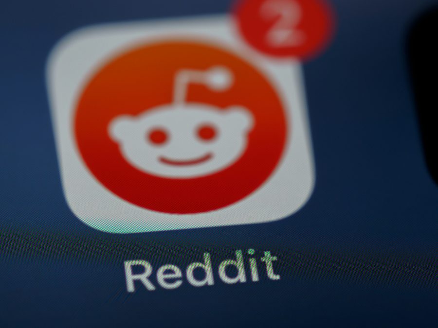 Close up of Reddit logo and app on smartphone home screen