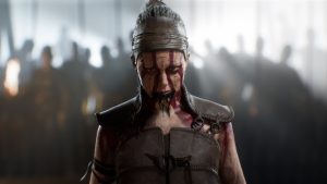 the title character Senua of Hellblade 2 stares ahead at the viewer, wearing traditional war paint of her Pictish people. The game is set in 9th century Iceland.