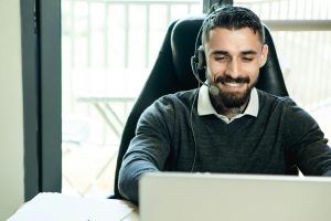man at computer who improves customer service
