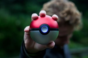 Pokeball in foreground held in hand