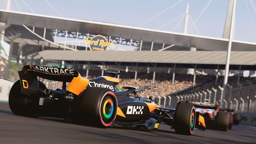 The McLaren car driven by Lando Norris rounds a turn by Hard Rock Stadium at the Miami Grand Prix, as seen in F1 24.