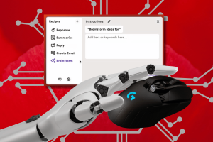 Logitech offers mouse and keyboard users free ChatGPT upgrade with AI Prompt Builder. A robotic hand with silver metallic fingers holds a black computer mouse on a red background. Text at the top of the image reads from left to right: "Recipes Instructions 0". Below that is a text box with the following options, top to bottom: "Rephrase", "Summarize", "Reply", "Create Email", "Brainstorm".
