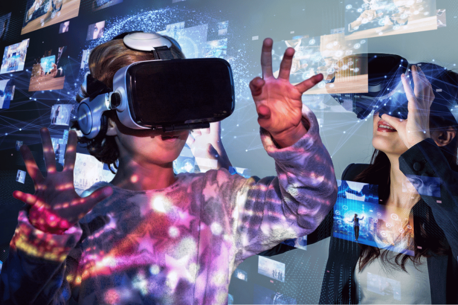 Meta VR headsets in schools to 'require teacher supervision'. Two individuals using virtual reality headsets, interacting with digital interfaces and virtual elements in a space filled with glowing digital graphics and connections.