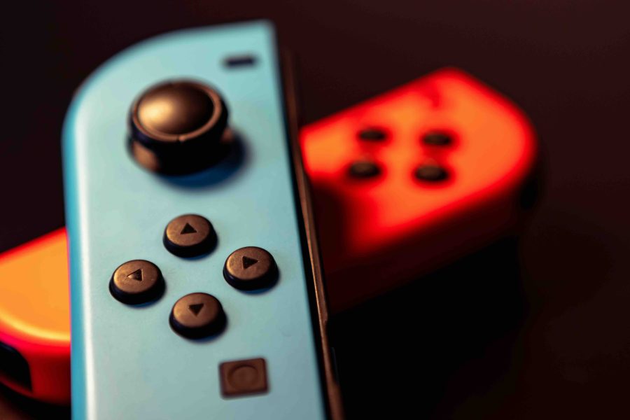 Original Nintendo Switch Joy-Cons shown in photo with a black background. The red Joy-Con is laid at the bottom, with the blue Joy-Con over the top. These could be different from Nintendo Switch 2 Joy-Cons.