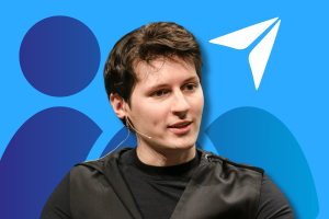 Telegram set to reach billion users in a year, founder says. An image of Pavel Durov, against a blue background with geometric shapes, including circles and a stylized paper plane which is a recognizable symbol of the messaging app Telegram. The individual appears to be in mid-speech, possibly during an interview or announcement, as indicated by the earpiece and microphone. The image's accompanying text suggests that this person is discussing the significant growth of the messaging platform, predicting that Telegram will reach a billion users within a year.