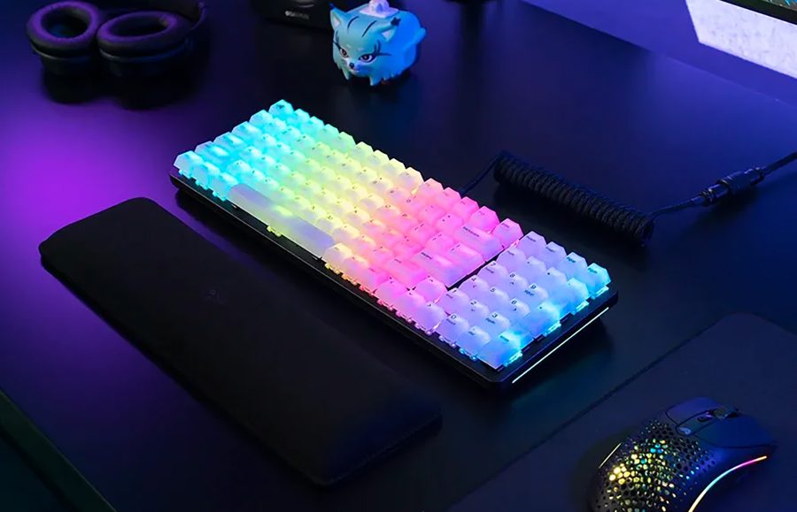 A desk setup with a Glorious Gaming keyboard on it.