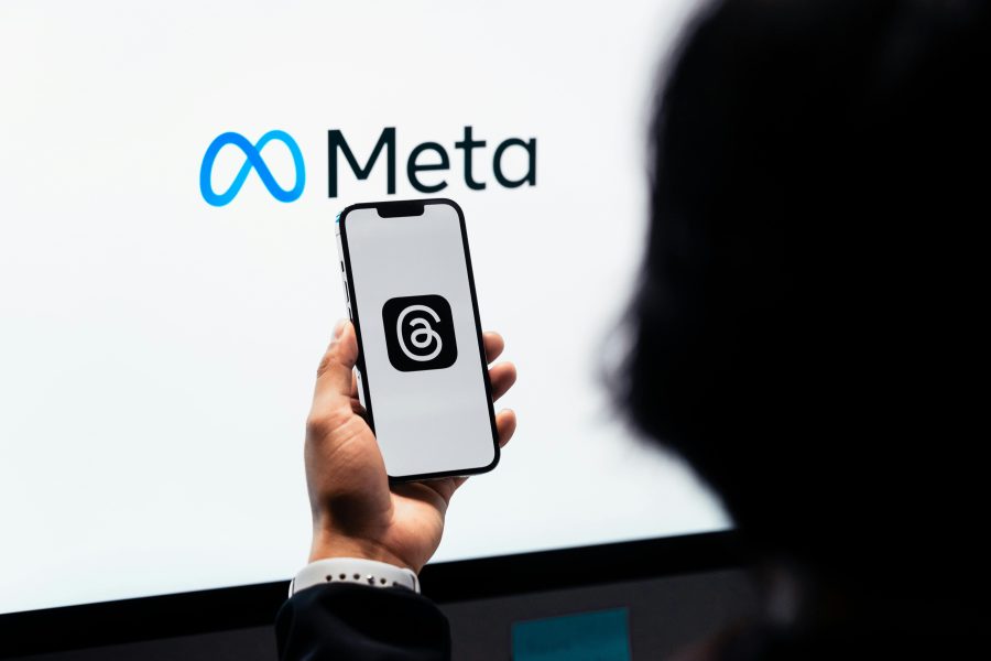 Meta logo and Threads app on a phone / Meta has sounded profit warning as AI spending soars