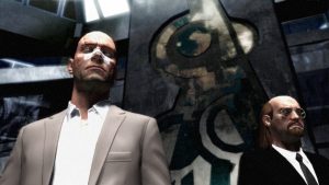 a scene from the video game Kane & Lynch, both titular characters are presented, Kane with a bandage across his nose and Lynch in sunglasses