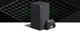 product image of an Xbox Series X tower-style console with a gamepad laying next to it