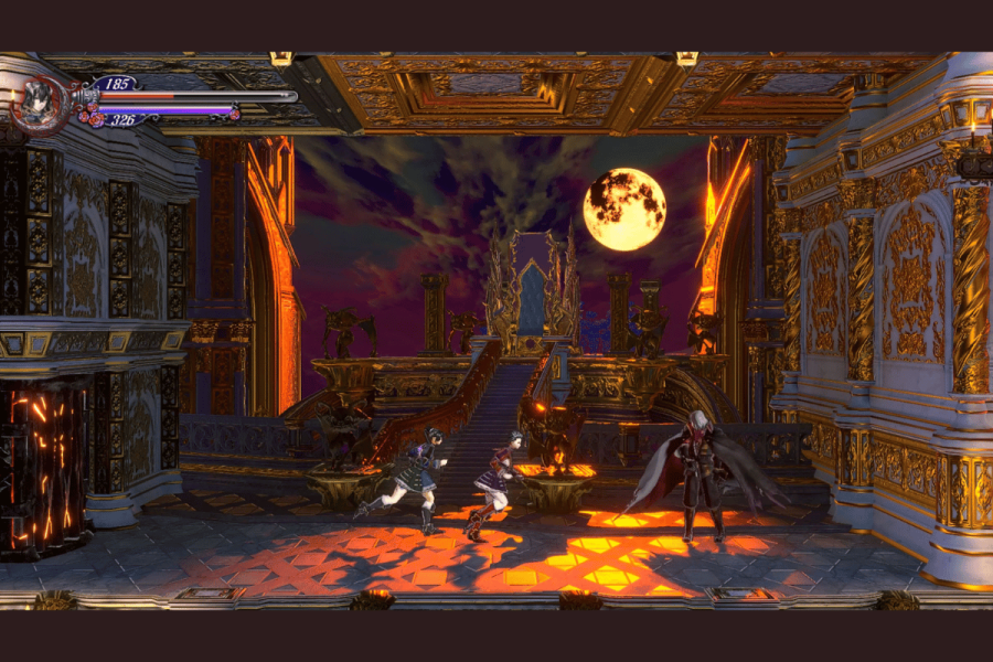 Final Bloodstained Ritual of the Night update adds new modes. This image depicts a scene from a video game showing a lavish, gothic-style interior with two characters engaged in combat. The environment is richly detailed with golden accents, intricate carvings, and statues, creating a dramatic and opulent atmosphere. In the background, a large, blood-red moon hangs in a twilight sky, viewed through an arched doorway flanked by classical columns and fiery braziers. The characters, one wielding a sword and the other with a demonic appearance, add a dynamic element to the ornate setting.