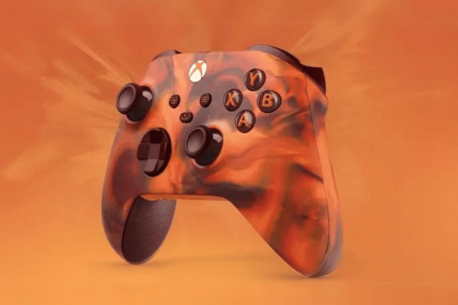 Microsoft retracts controversial Xbox controller 'Feel the Burn' tagline amid studio closures. Xbox controller shows orange fire design on gamepad.