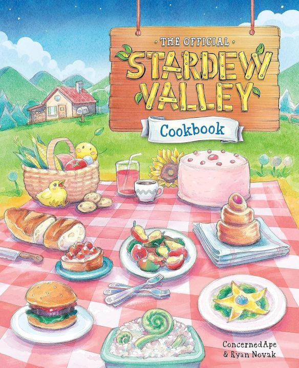 the front cover of the starfew valley cookbook. it is an illustration of a picnic with many delicious looking food items on the chequered cloth.