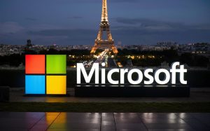 a night shot of the city of Paris with a large microsoft logo in the foreground, photo