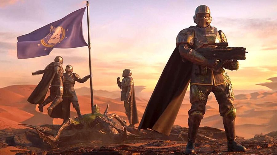 In a scene from Helldivers 2, a caped fighter brandishes his rifle while two teammates raise a flag and celebrate behind him