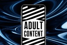 A phone screen with "Adult content" written on the screen