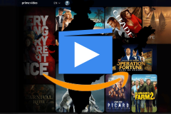 This image shows the user interface of the Amazon Prime Video streaming platform. The interface is in English and features a variety of movie and TV show posters arranged in a grid. A large play button is superimposed over the middle of the image, partially obscuring some of the content. Notable titles visible include "Every Breath You Take", "Carnival Row", "Citadel", "Operation Fortune: Ruse de Guerre", "Star Trek: Picard", and "Clarkson's Farm 2". The design includes the Prime Video logo at the top left and a language selection menu at the top center. Amazon buys parts of MX Player assets to boost India presence.