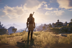 Obsidian's Avowed to mirror The Outer Worlds in structure and length. A character in a fantasy role-playing game stands on a grassy hill at sunset, looking out towards a distant town. The landscape is adorned with rocky formations, lush grass, and a few trees, under a partly cloudy sky. The character is clad in medieval-style armor and holds a sword, with their back facing the viewer. The scene conveys a sense of adventure and exploration in a vast, open world.