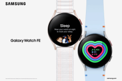 Samsung launches Galaxy Watch FE - its new affordable wearable. The image shows an advertisement for the Samsung Galaxy Watch FE. It features two different watch models, both with round faces and sleek designs. The watch on the left is pink with a white strap and displays a "Sleep" monitoring feature on its screen, showing a cartoon of a person and a penguin sleeping. The watch on the right has a blue strap and shows a colorful heart-shaped activity tracker that details steps taken, heart rate, and calories burned. The Samsung logo is prominently displayed at the top, with the product name "Galaxy Watch FE" below the left watch.