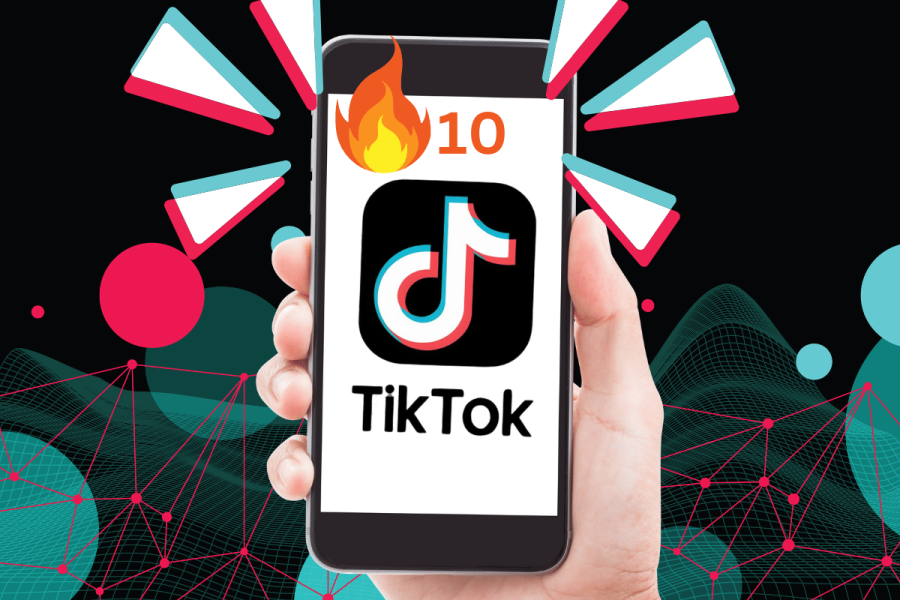 TikTok tests streaks in messages, echoing Snapchat's popular feature. This image showcases a hand holding a smartphone displaying the TikTok app. The screen of the phone features a large, vibrant notification symbolizing "10 streaks" with a fiery icon, emphasizing the concept of active and ongoing interaction, likely within the platform's messaging feature. The background is a digital abstract graphic with interconnected lines and nodes, suggesting a network or digital connectivity theme. Bright geometric shapes radiate outward from the phone, enhancing the dynamic and modern feel of the image, possibly representing the app's energetic and engaging nature.