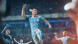 a Manchester City football player celebrates a score in EA Sports FC 24, leaping into the air and pointing his finger in triumph