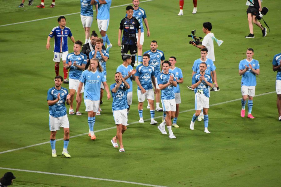 Manchester City footballers on the pitch in 2023. Can see them clapping and looking at fans after a game.