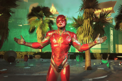New Suicide Squad cutscene reveals the return of Flash and possibly the Justice League. The image depicts The Flash from the game "Suicide Squad: Kill the Justice League," standing in a devastated urban setting with palm trees and scattered debris around him. His costume is vibrant red with a golden lightning bolt emblem on his chest, and he is gesturing outward with his hands in a welcoming or questioning pose. The environment suggests recent destruction, and The Flash's expression and body language indicate a moment of calm or inquiry amidst the chaos.