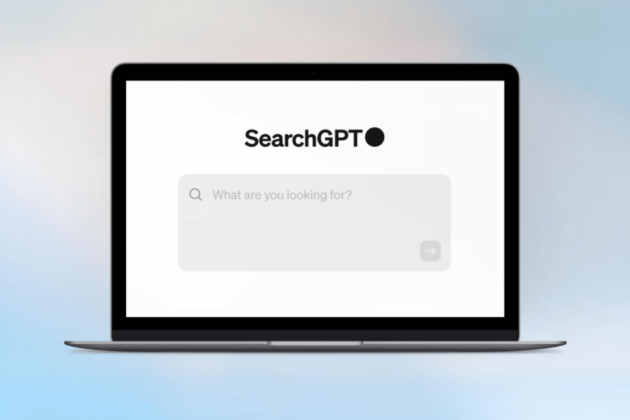 OpenAI launches AI engine SearchGPT to rival Google's Gemini. A laptop displaying the SearchGPT interface with a minimalist design, featuring a prominent SearchGPT logo and a search bar asking "What are you looking for?". The background is a soft gradient.