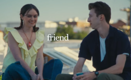 Screengrab of the friend AI advert. A woman wears a friend necklace and chats to her male friend on a rooftop