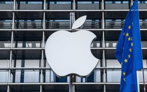 Apple logo on a building with the European Union flag next to it