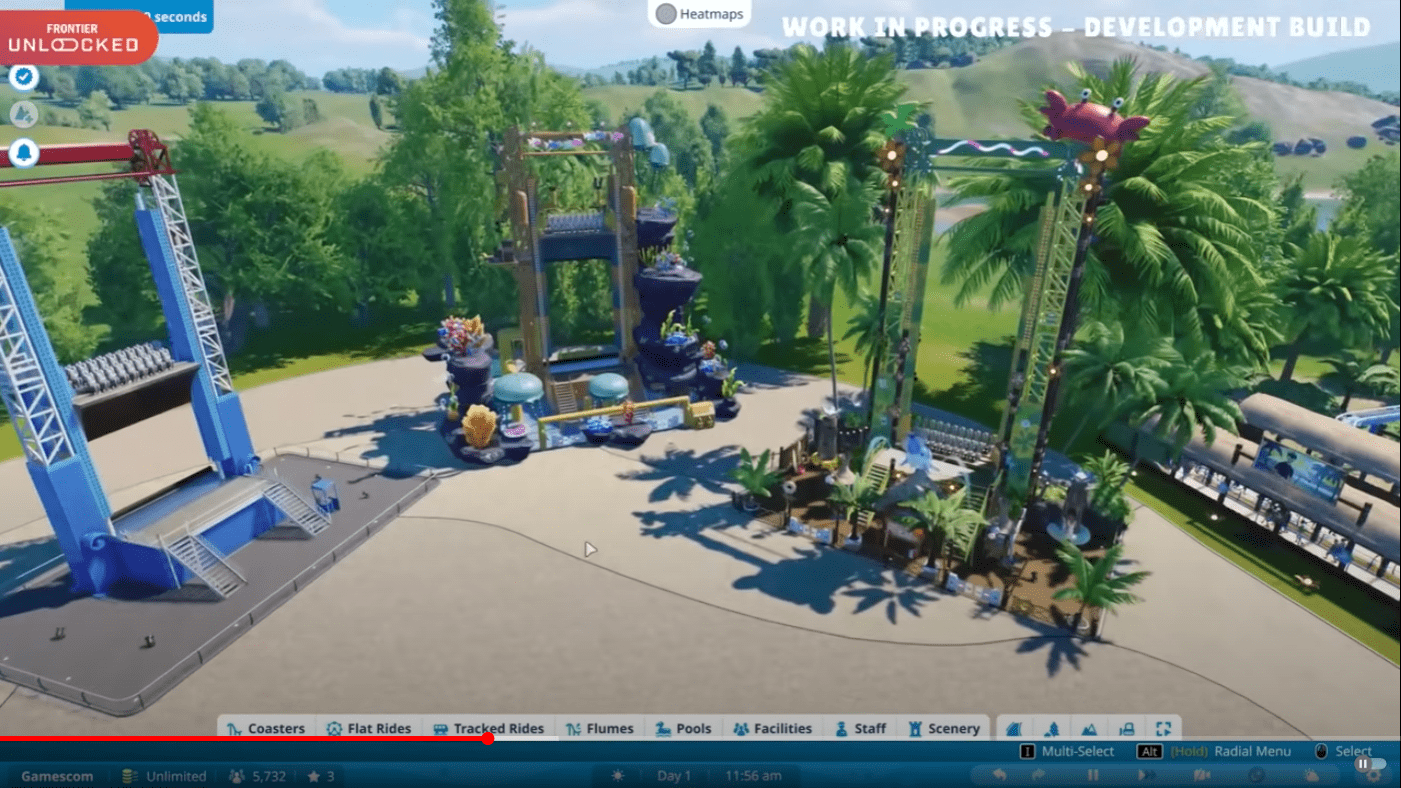 three versions of a ride in planet coaster 2, one plain and two pre-decorated