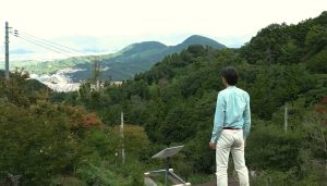 Starlink used in mountain range, with man standing there looking out at the landscape.