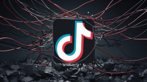 A dark background with the TikTok logo in the center. The logo is surrounded by a tangled web of red and black wires. The scene symbolizes the spread of misinformation and propaganda.